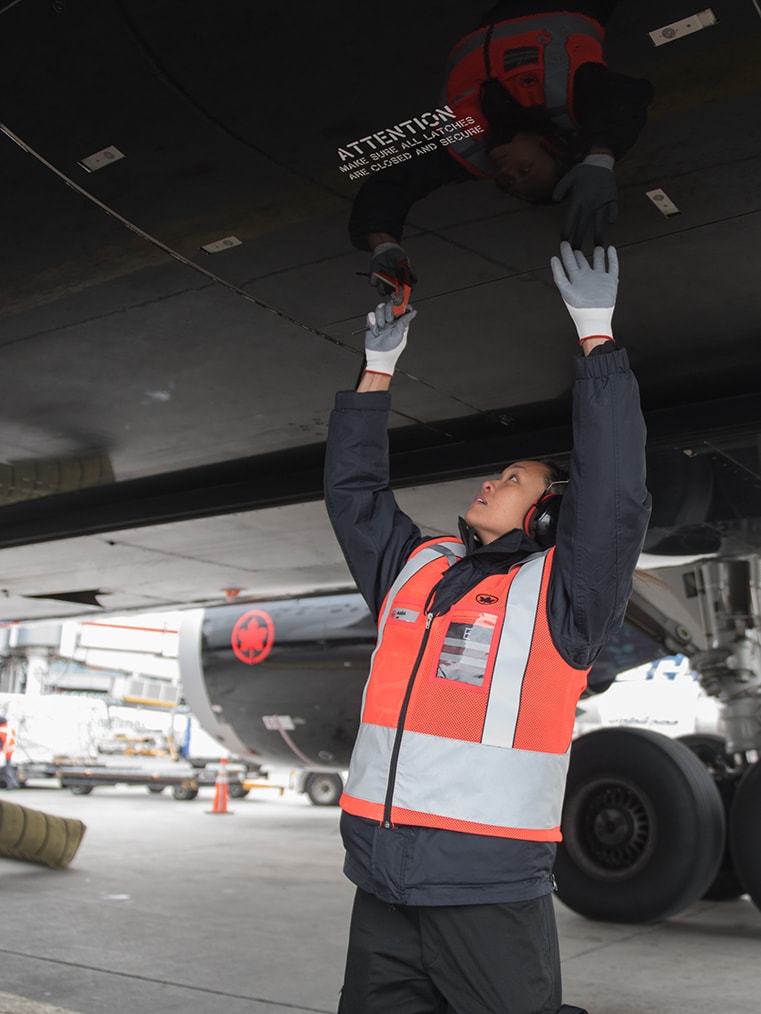 An employee attends to an Air Canada plane